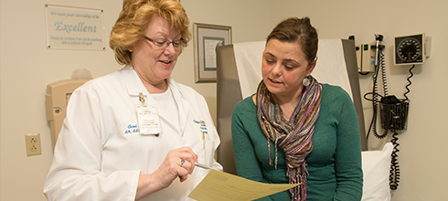 A physician meets with a lung transplant patient