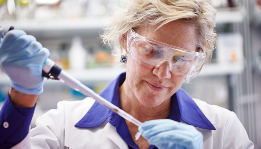 A lab technician works with a sample