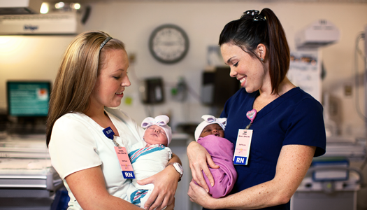 A woman receives a checkup while holding her newborn.