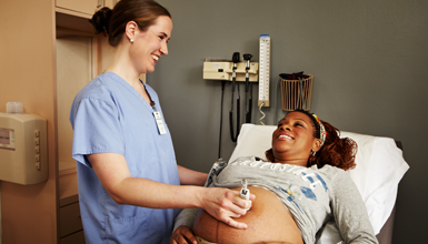 A pregnant woman receives an ultrasound.