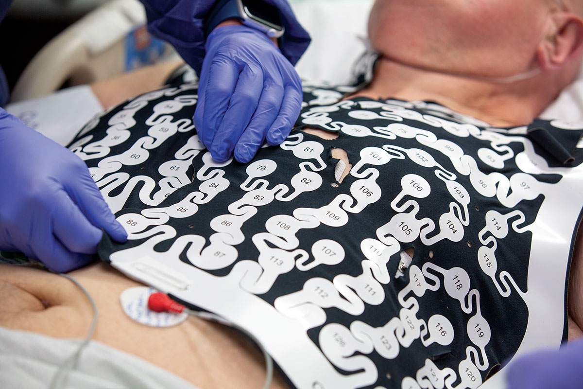 A patient with ventricular tachycardia is wearing a vest of electrodes during a noninvasive heart-mapping procedure called electrocardiographic imaging