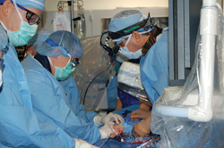 Surgeons performing valve repair surgery