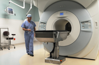 Dr. Ralph Dacey, chief of neurological surgery, positions the magnet in the intra-operative MRI operating suite.