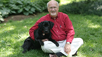 A man sits with his dog