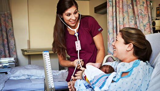 A woman and her newborn receive a checkup