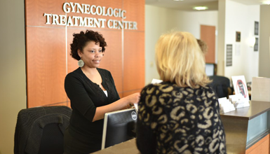 A desk attendant helps a visitor of the Gynecologic Treatment Center.