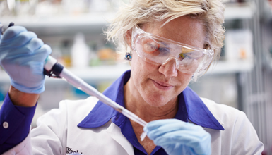 A lab tech works with a sample