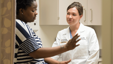 A woman discusses health topics with her gynecologist