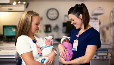 Nurses providing care for newborns